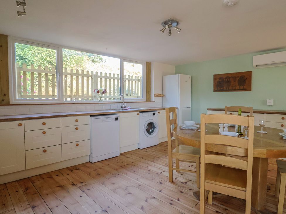 A kitchen with a table and chairs at The Linhay Cotleigh Nr. Honiton