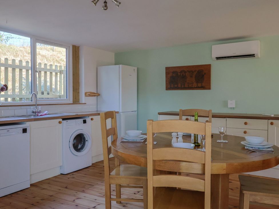 A kitchen with a table and chairs at The Linhay Cotleigh Nr. Honiton