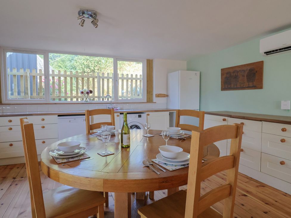 A kitchen with a dining table and chairs at The Linhay Cotleigh Nr. Honiton