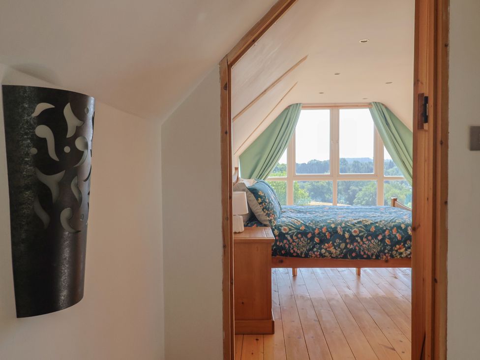 A bedroom with a bed and window view at The Linhay Cotleigh Nr. Honiton