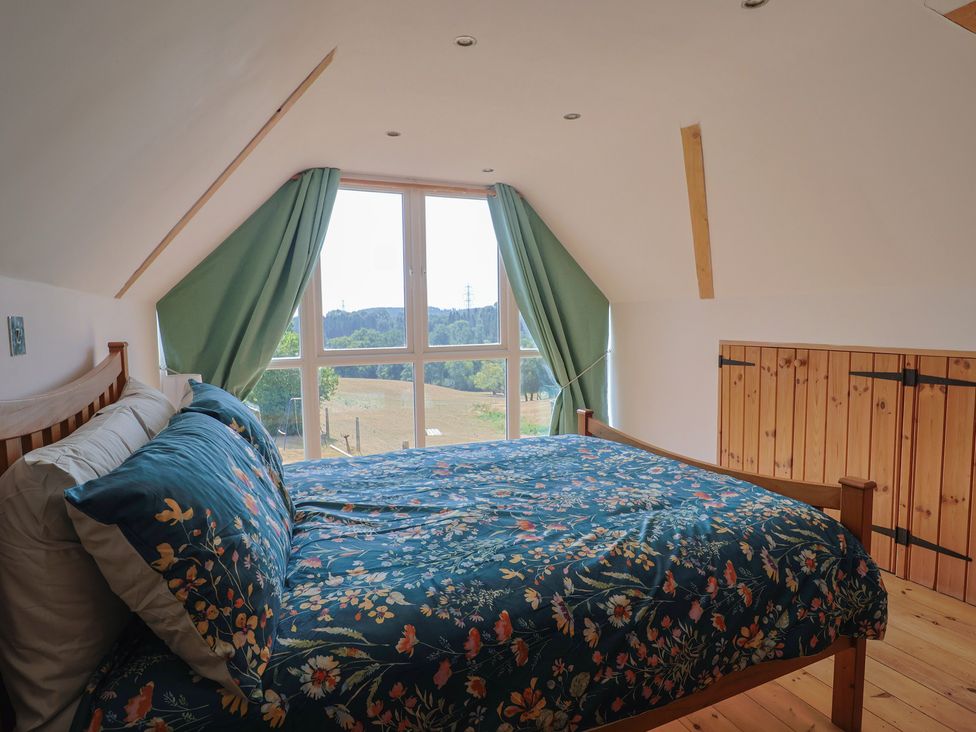 A bedroom with a bed and window at The Linhay Cotleigh Nr. Honiton