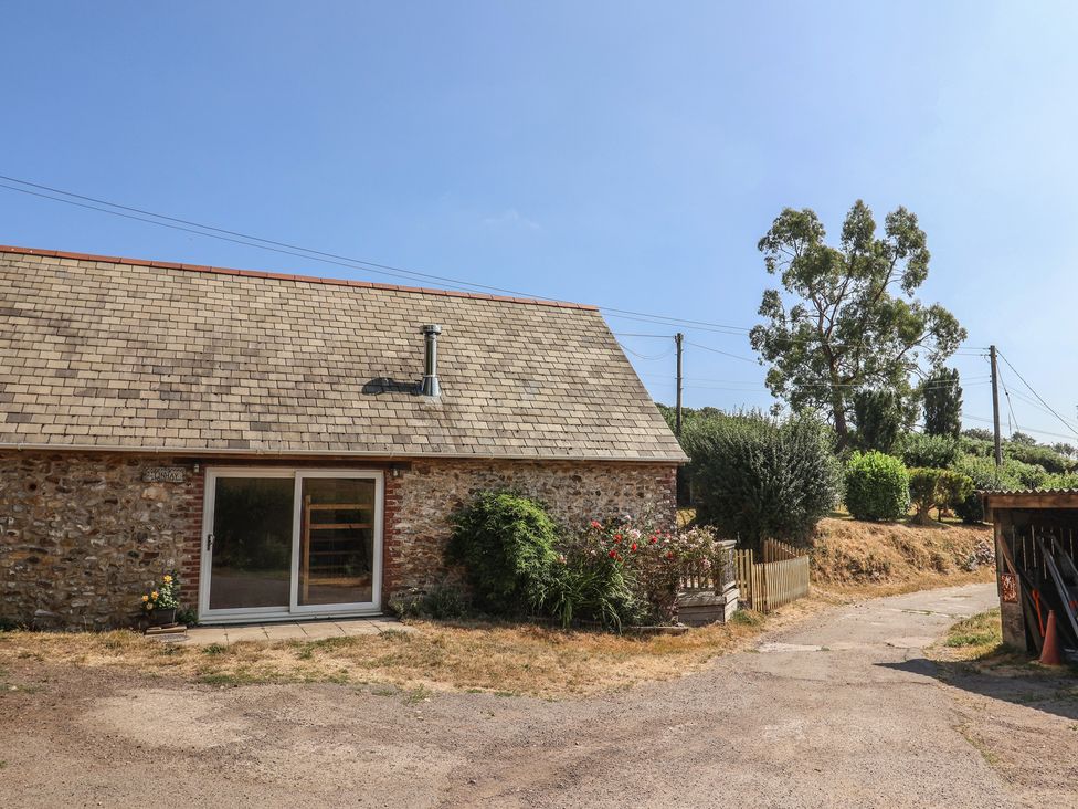 An outdoor view of a house with a garden at The Linhay Cotleigh Nr. Honiton