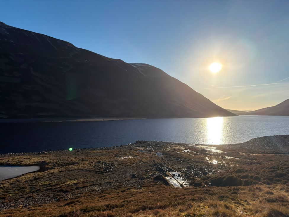 A scenic view of a lake surrounded by mountains at 1 Station Cottages