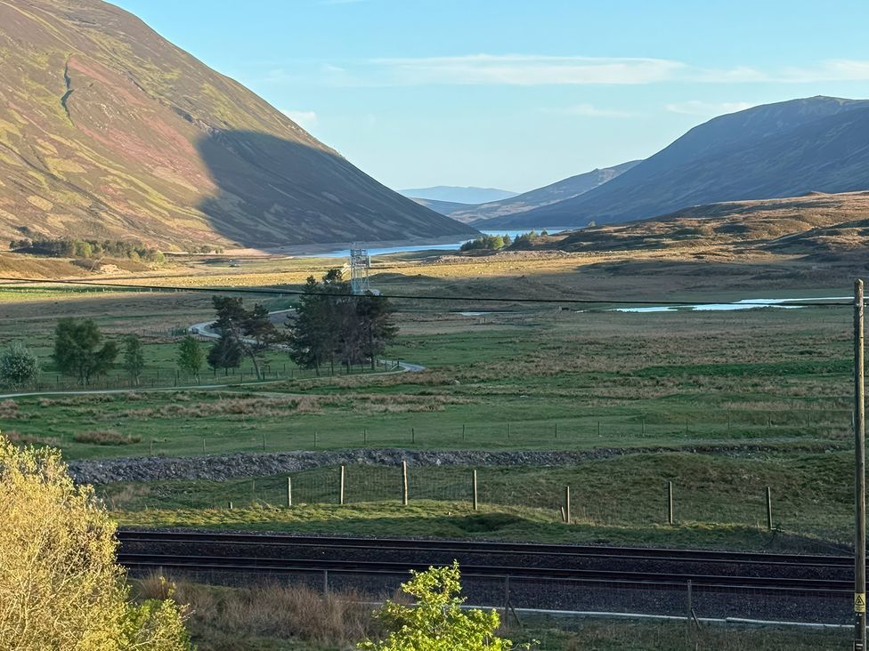 A view of mountains and a river in a valley near railroad tracks at 1 Station Cottages