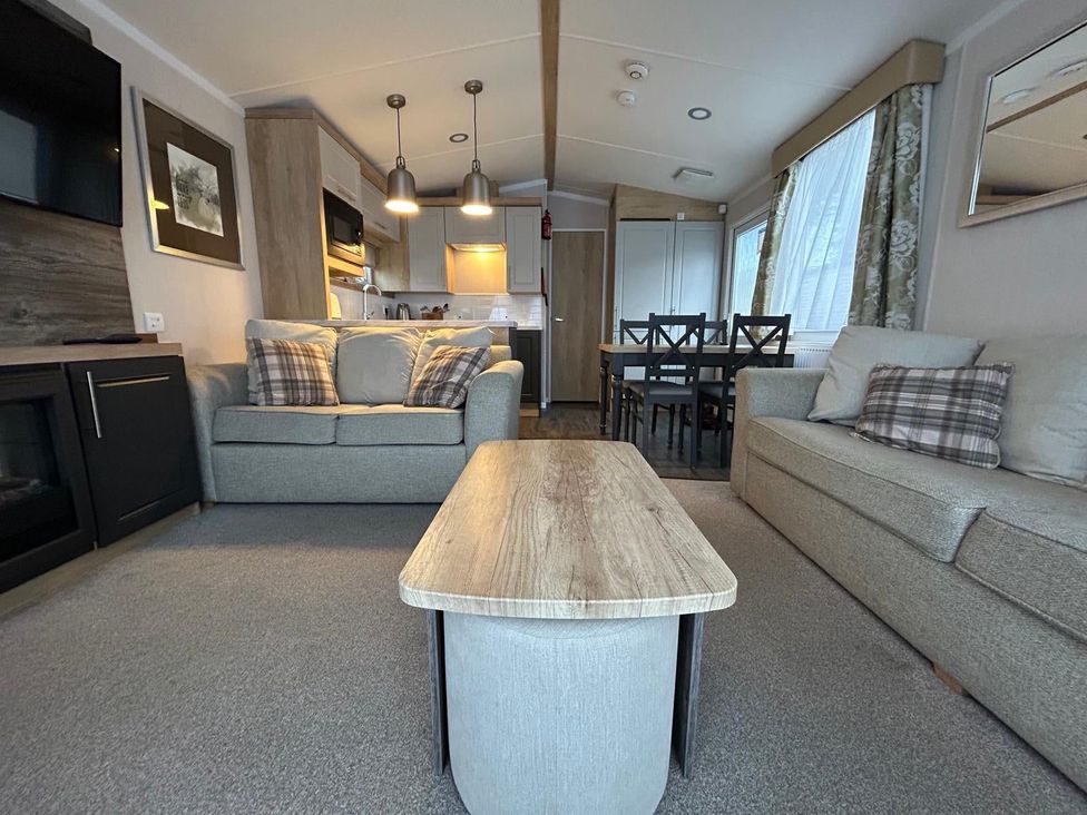 A living room with a sofa and table at Rockley Park in Poole