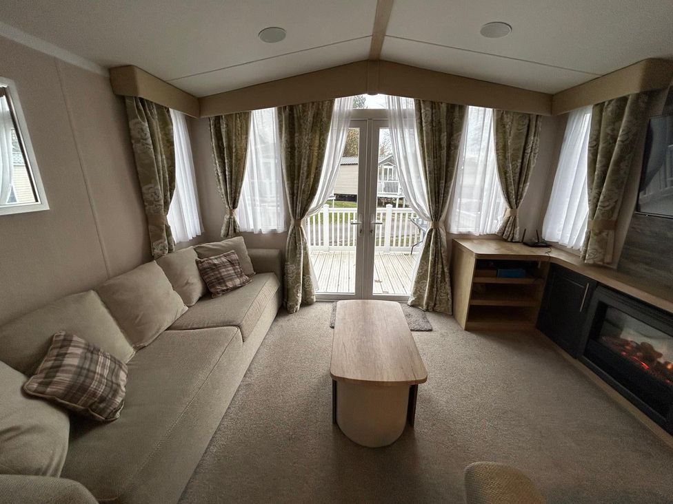 A living room with a sofa and a coffee table at Rockley Park in Poole
