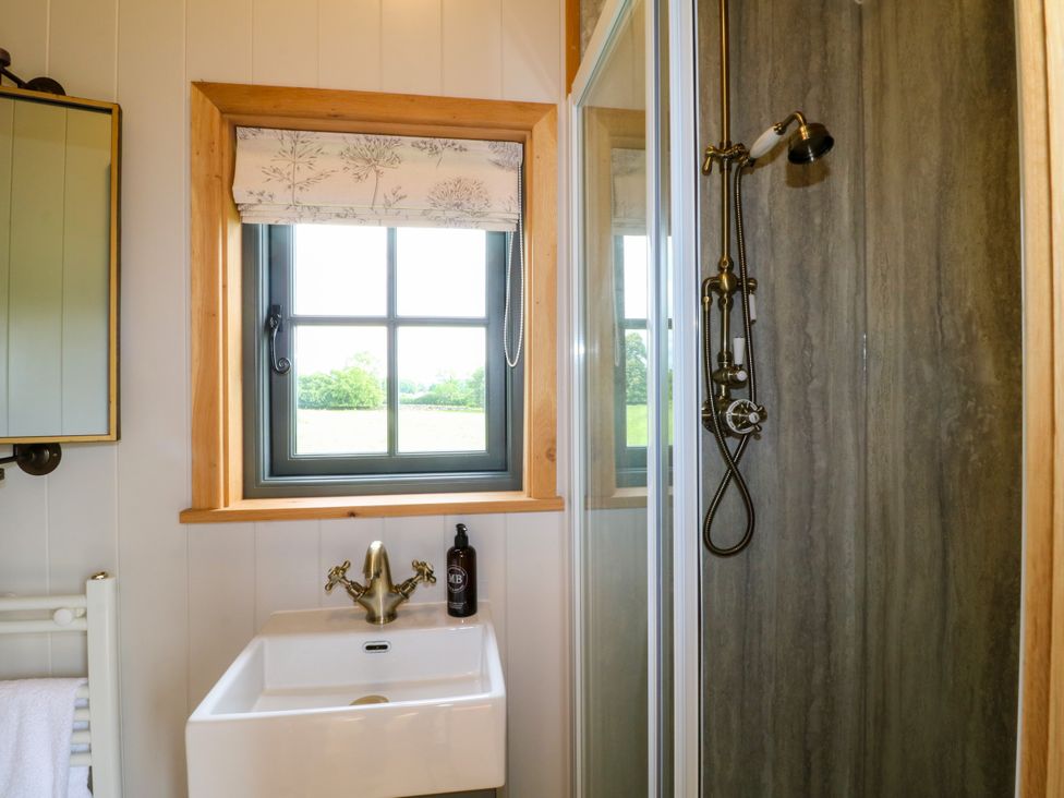 A bathroom with a sink and shower at Pike House Farm Shepherds Hut 2 Thorpe near Ashbourne