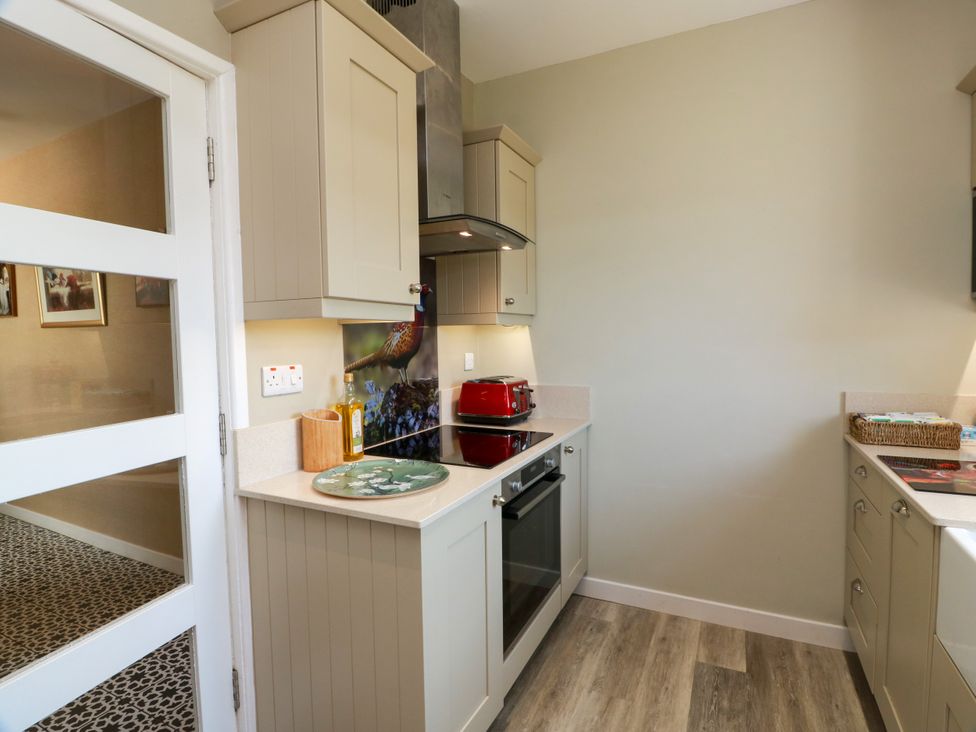 A kitchen with counter and stove at Waterside Lodge in Annan