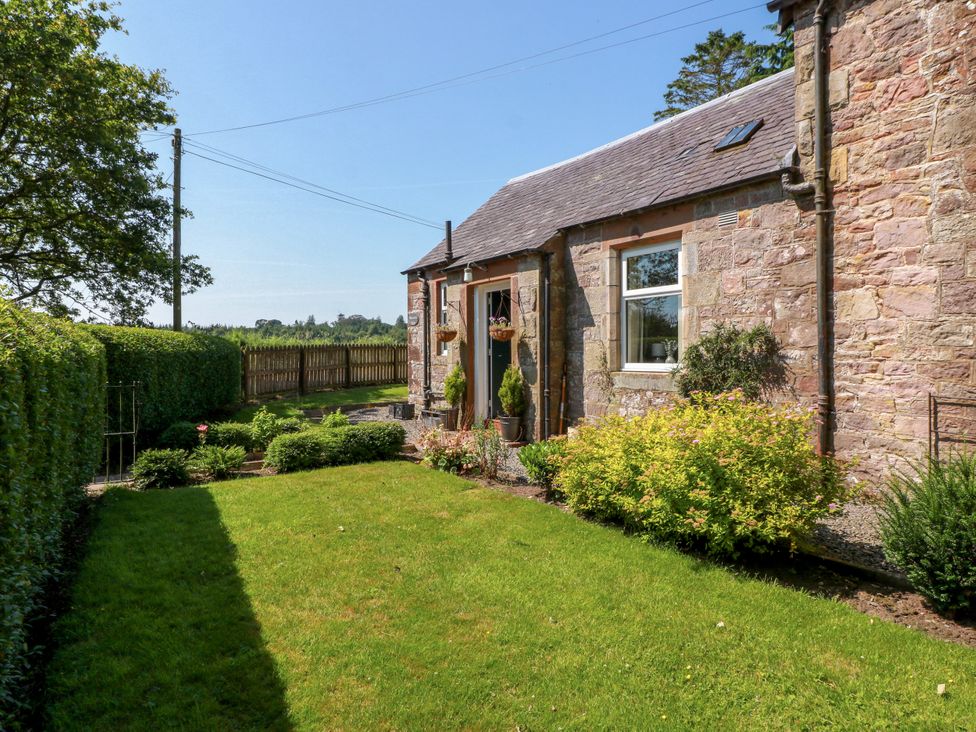 A house exterior with a garden at Waterside Lodge in Annan