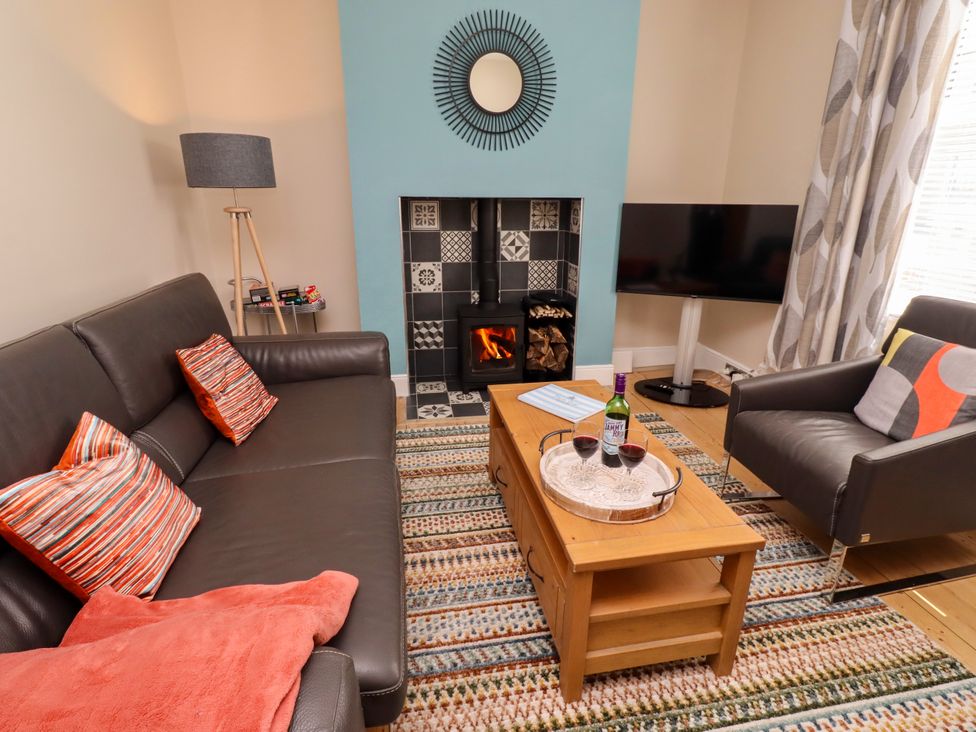 A living room with a coffee table and fireplace at Farnecrest in Seahouses
