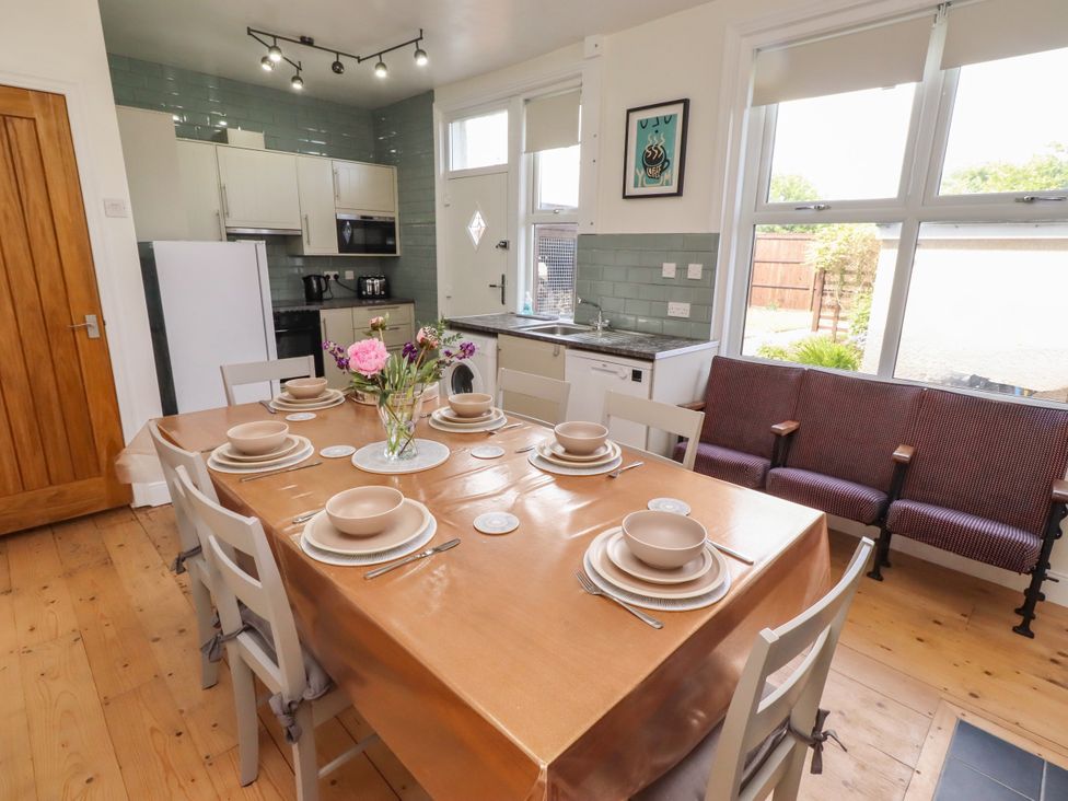 A dining room with a table set for dinner at Farnecrest in Seahouses