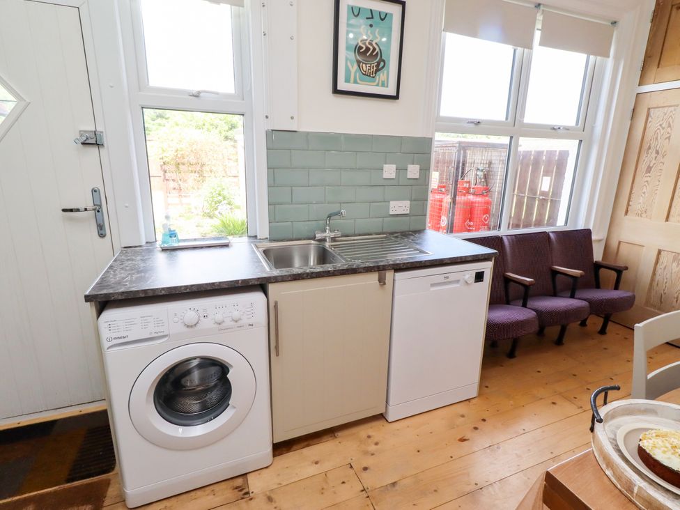 A kitchen with a washing machine and dishwasher at Farnecrest in Seahouses
