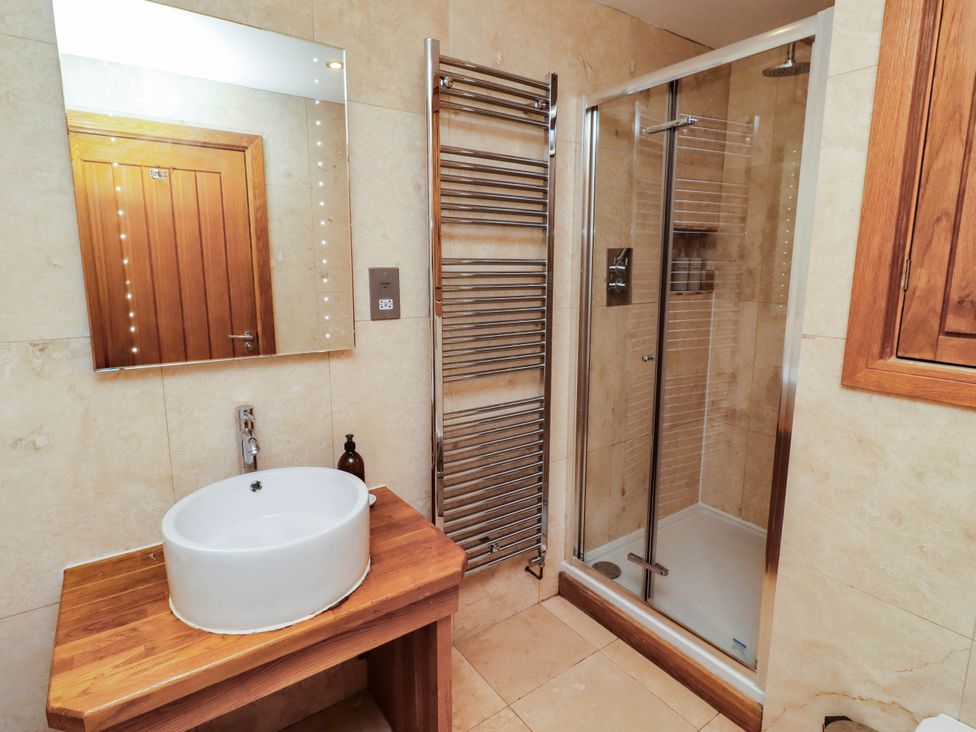 A bathroom with a shower and wash basin at Alma House in Seahouses
