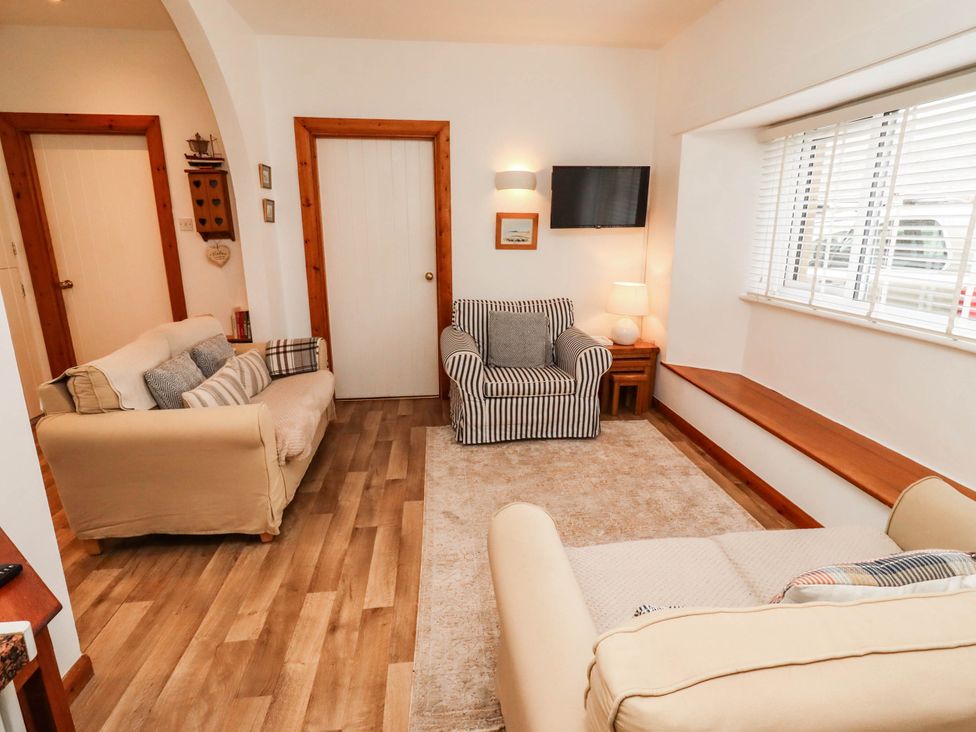 A living room with two sofas and a television at Spinnaker