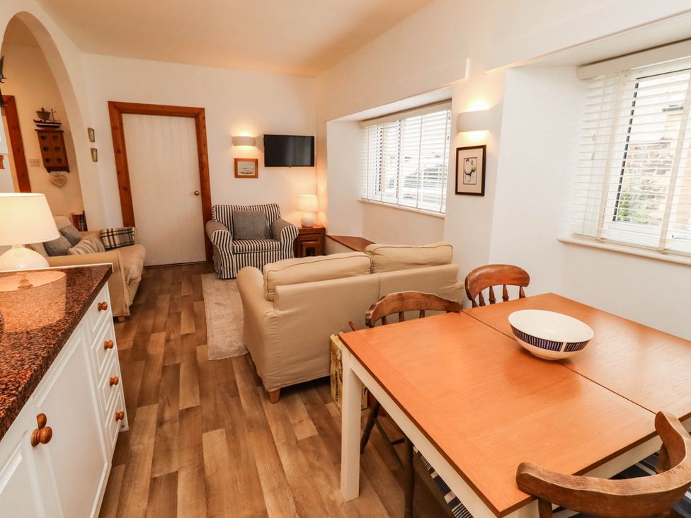 A living room with furniture and a table at Spinnaker