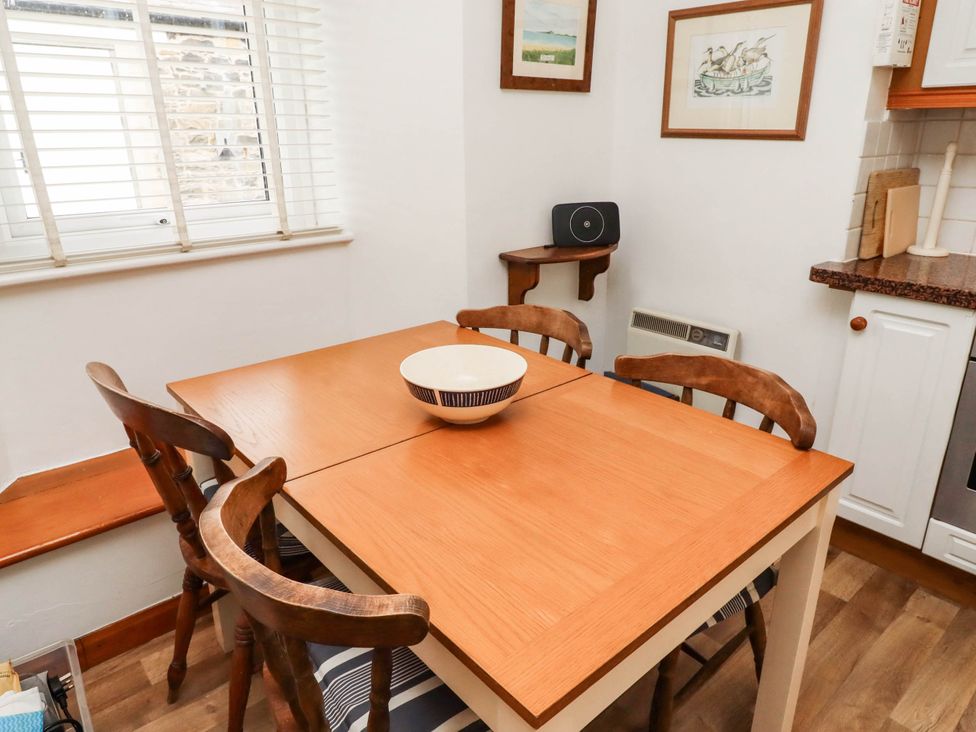 A dining room with a table and chairs at Spinnaker