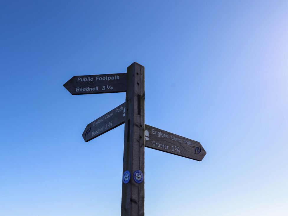 A signpost indicating directions and distances to Beadnell and Croster