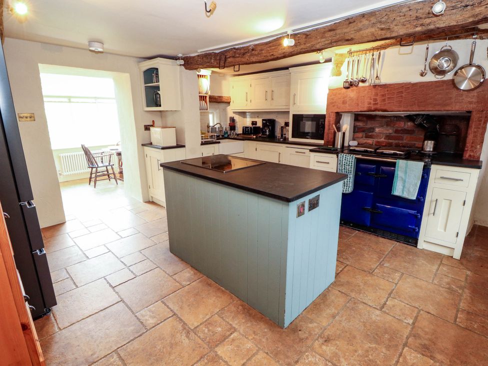 A kitchen with a blue cooker and island at Claybottom Farm near Hesket Newmarket
