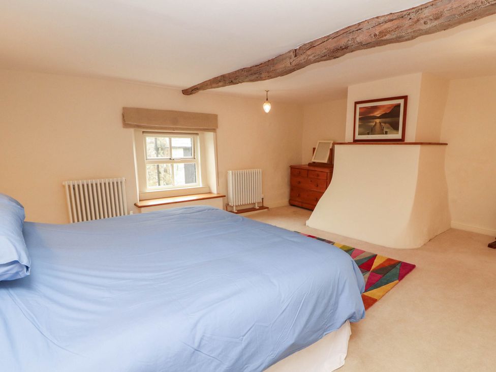 A bedroom with a bed and window at Claybottom Farm near Hesket Newmarket