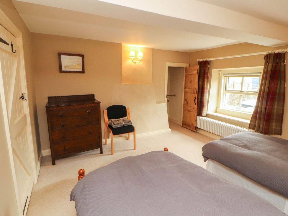 A bedroom with beds and furniture at Claybottom Farm near Hesket Newmarket