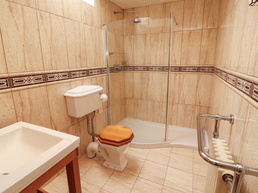 A bathroom with a shower, toilet, and sink at Claybottom Farm near Hesket Newmarket