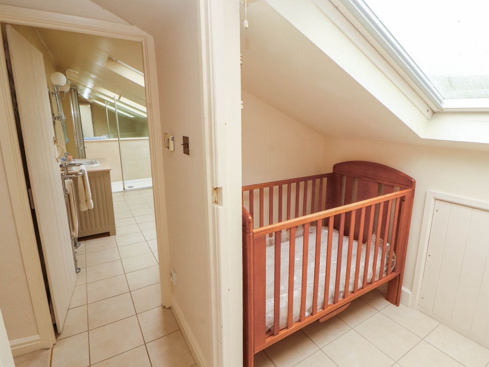 A bathroom with a shower and a crib at Claybottom Farm near Hesket Newmarket