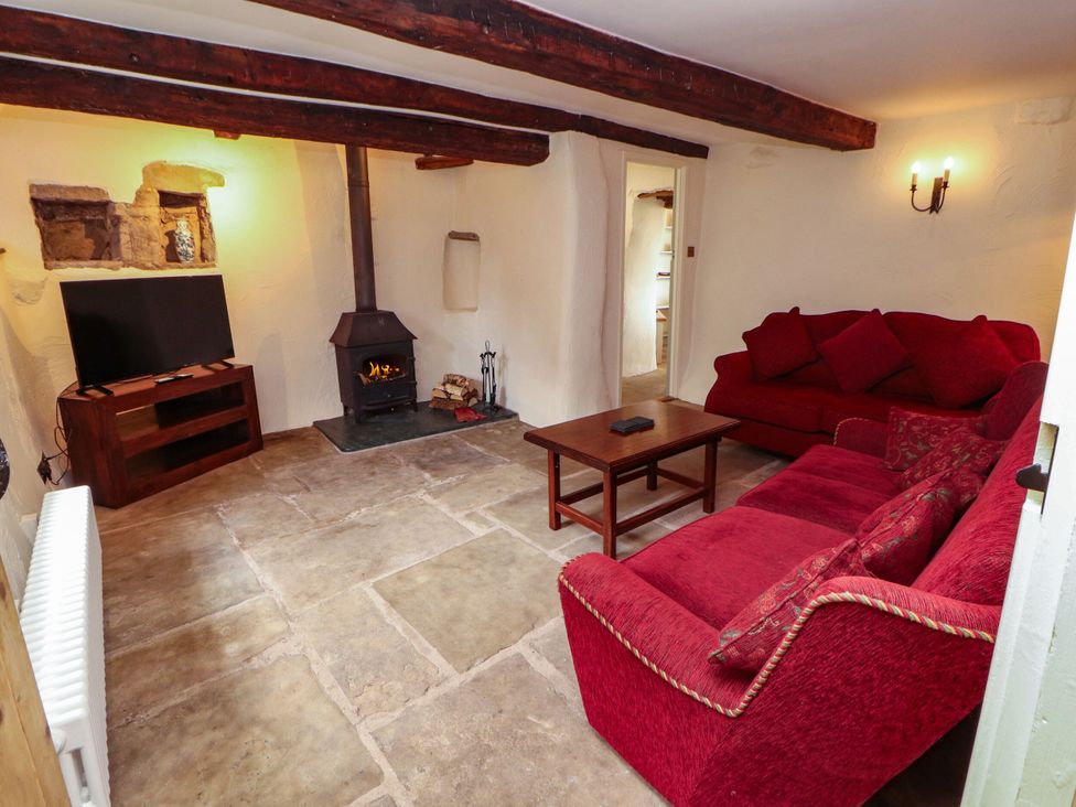 A living room with a sofa and television at Claybottom Farm Hesket Newmarket