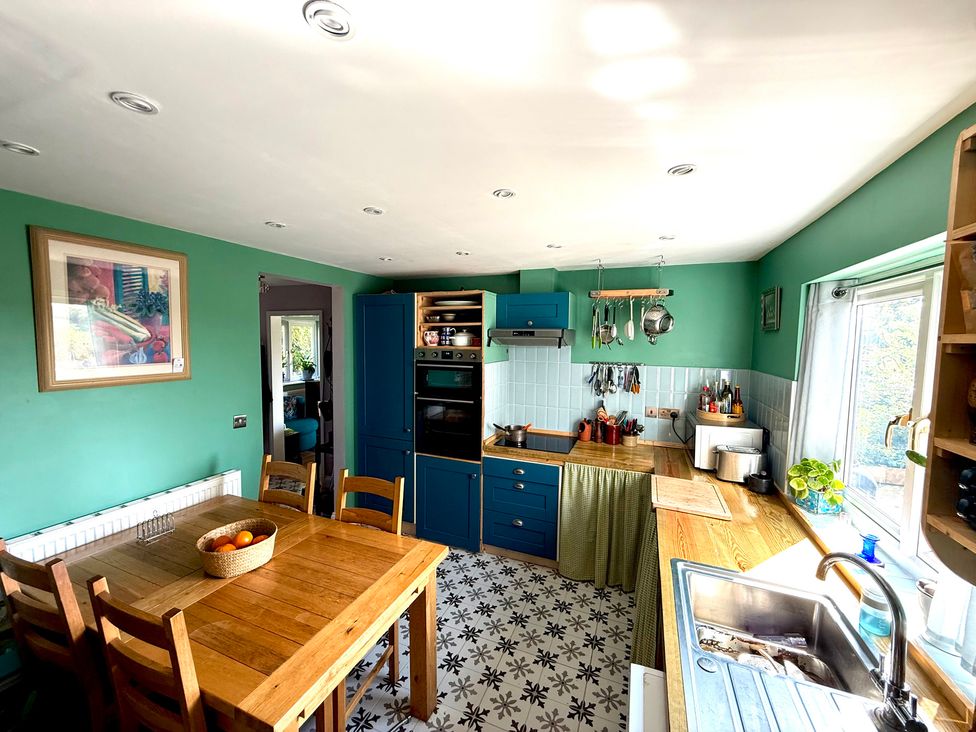 A kitchen with table and chairs at Fables Cottage in Otley, Suffolk