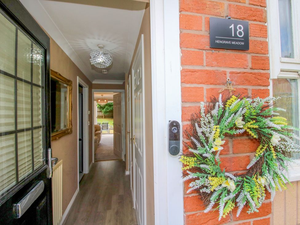 A hallway with a mirror and a wreath at 18 Hengrave Meadow Telford