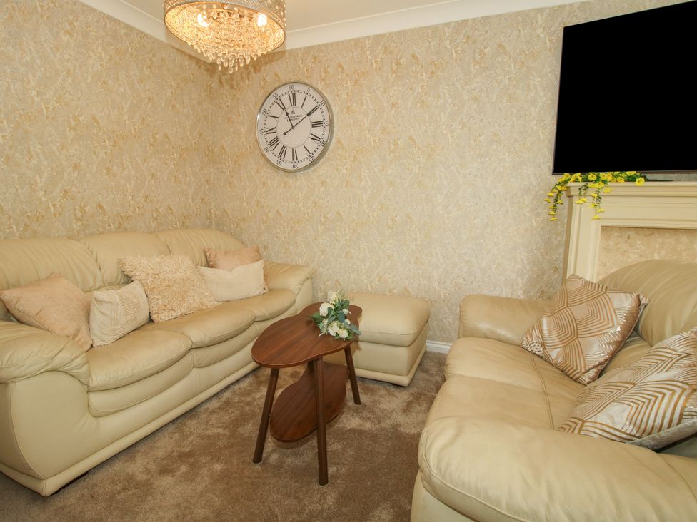 A living room with a sofa and coffee table at 18 Hengrave Meadow in Telford