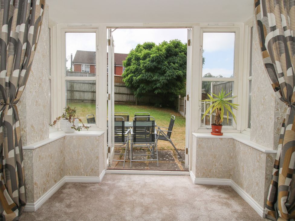 A sunroom with windows and plants at 18 Hengrave Meadow in Telford