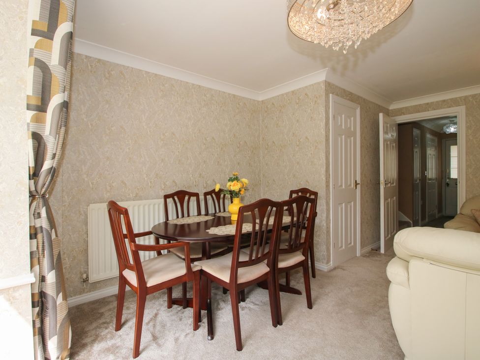 A dining room with a table and chairs at 18 Hengrave Meadow in Telford