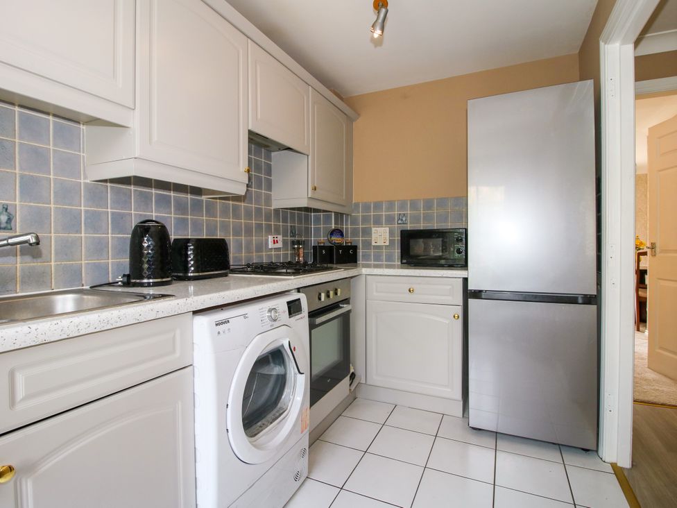 A kitchen with appliances and cabinets at 18 Hengrave Meadow in Telford