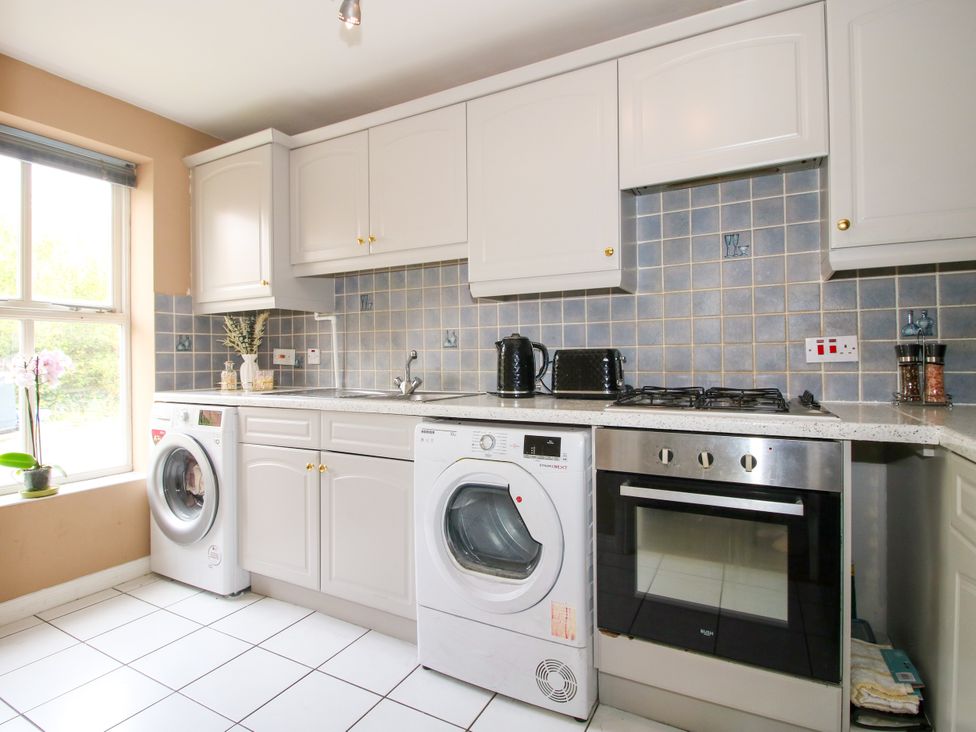 A kitchen with appliances including a washing machine and oven at 18 Hengrave Meadow Telford