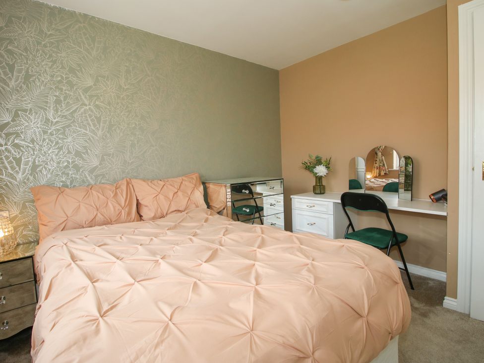 A bedroom with a bed and vanity at 18 Hengrave Meadow in Telford