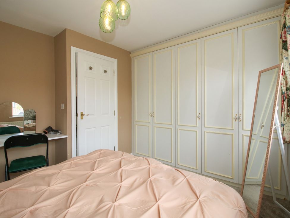 A bedroom with a bed and wardrobe at 18 Hengrave Meadow in Telford