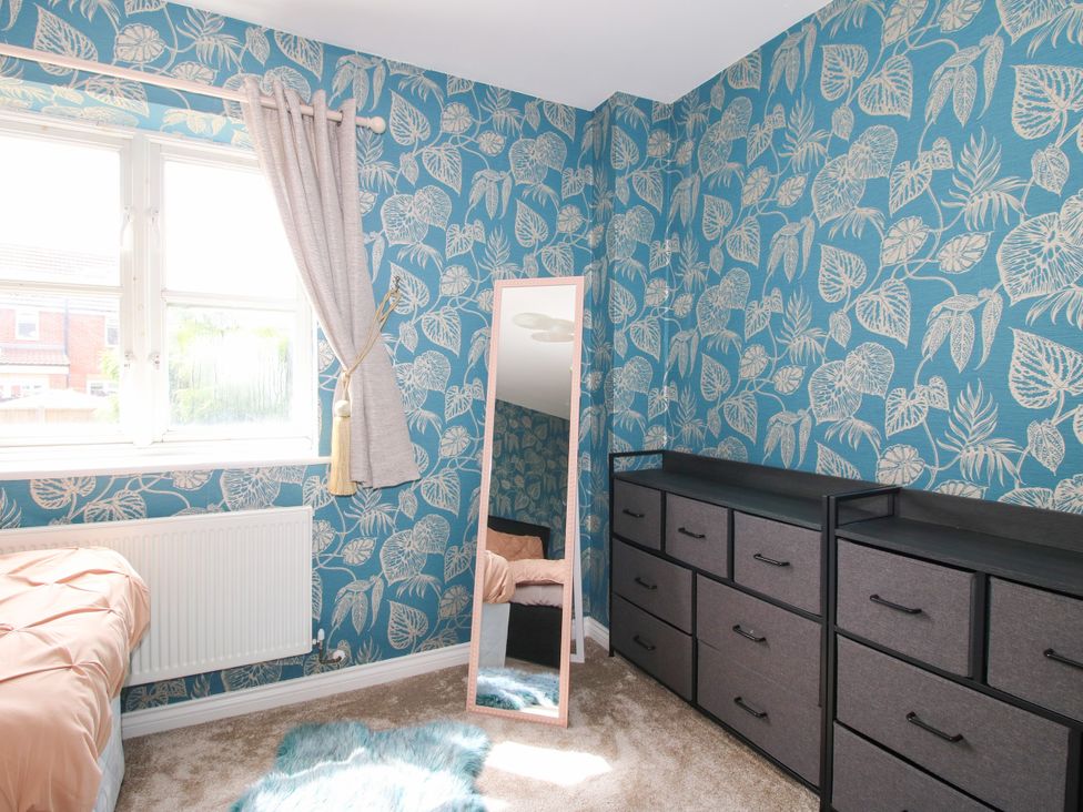 A bedroom with a bed, mirror, and storage unit at 18 Hengrave Meadow, Telford