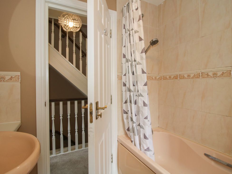 A bathroom with a bathtub and sink at 18 Hengrave Meadow in Telford