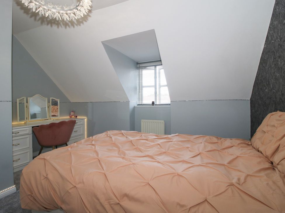 A bedroom with a bed and desk at 18 Hengrave Meadow in Telford