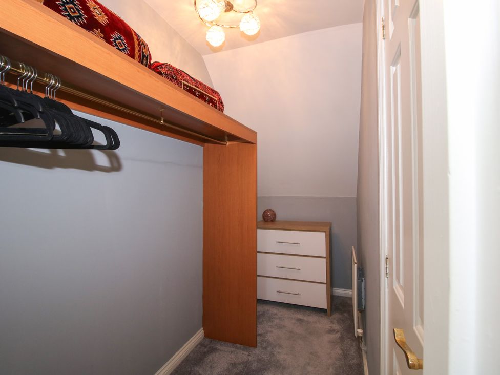 A closet with clothing rack and chest of drawers at 18 Hengrave Meadow in Telford