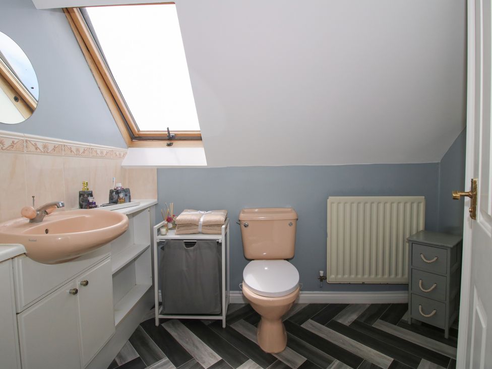 A bathroom with a washbasin, toilet, and shelf unit at 18 Hengrave Meadow in Telford