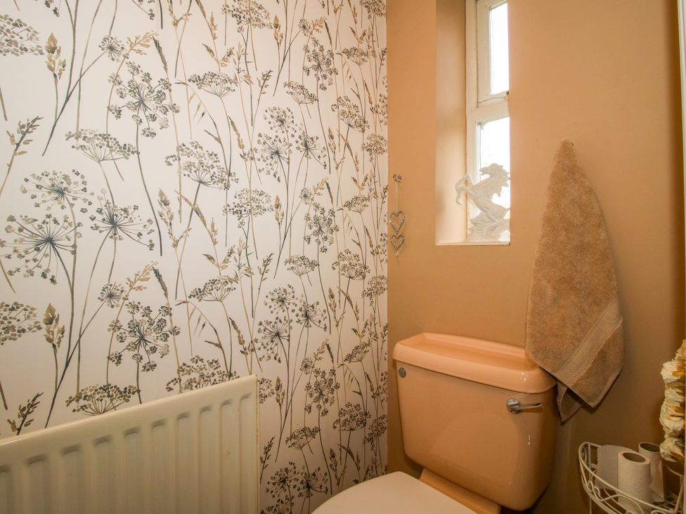 A bathroom with a toilet and decorative wall at 18 Hengrave Meadow Telford
