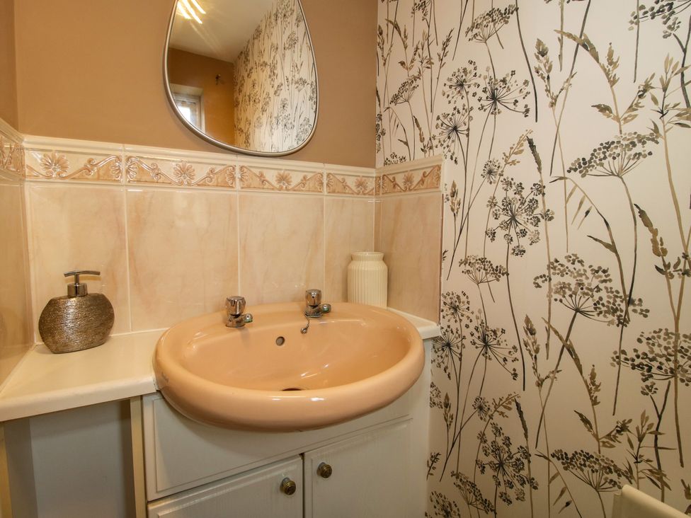 A bathroom with a sink and a mirror at 18 Hengrave Meadow Telford