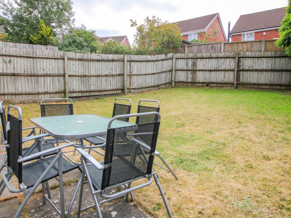 A garden with a table and chairs at 18 Hengrave Meadow in Telford
