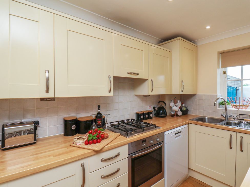 A kitchen with cabinets and appliances at The Cosy Haven in Malton