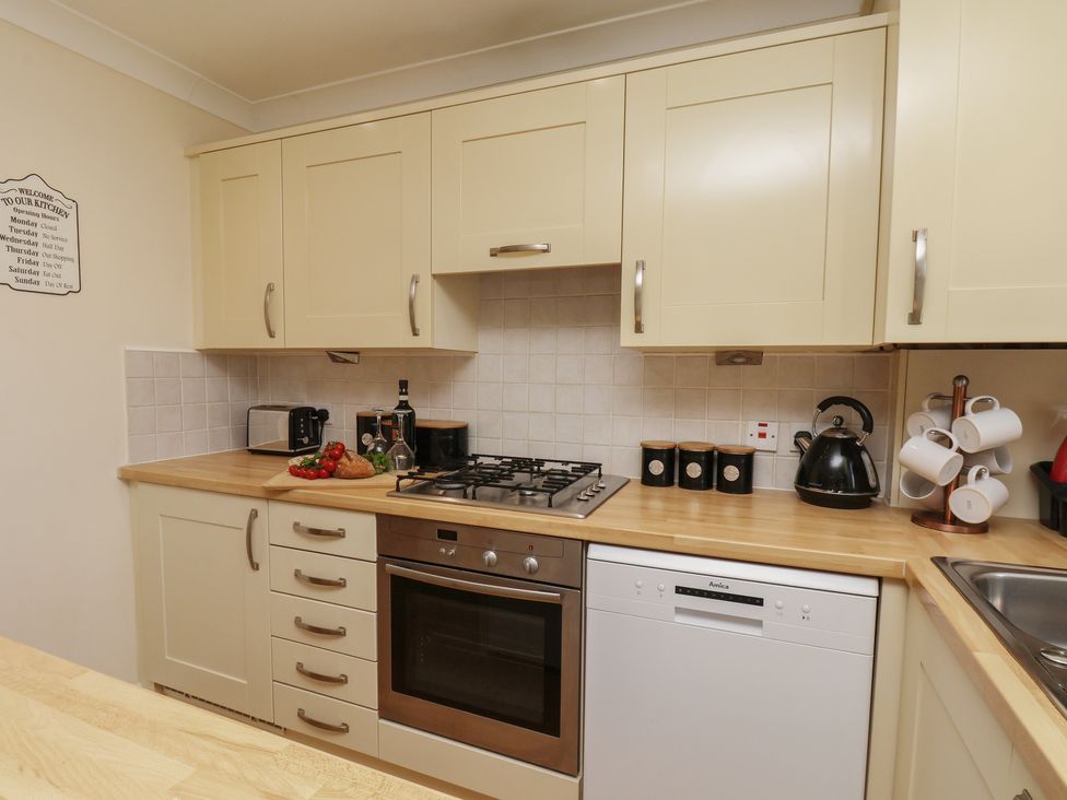 A kitchen with appliances and utensils at The Cosy Haven in Malton