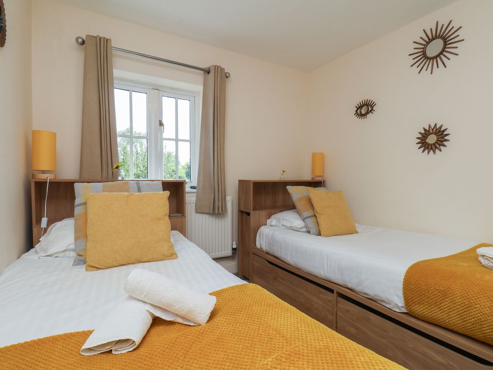 A bedroom with two single beds at The Cosy Haven in Malton