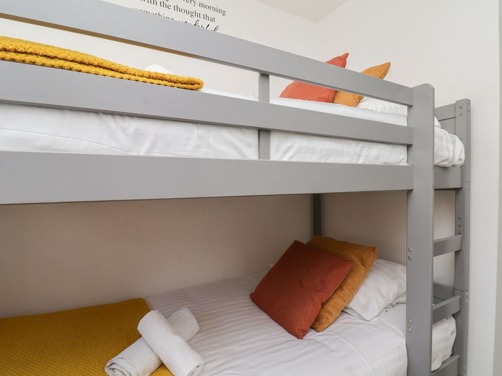 A bunk bed with pillows and towels at The Cosy Haven in Malton