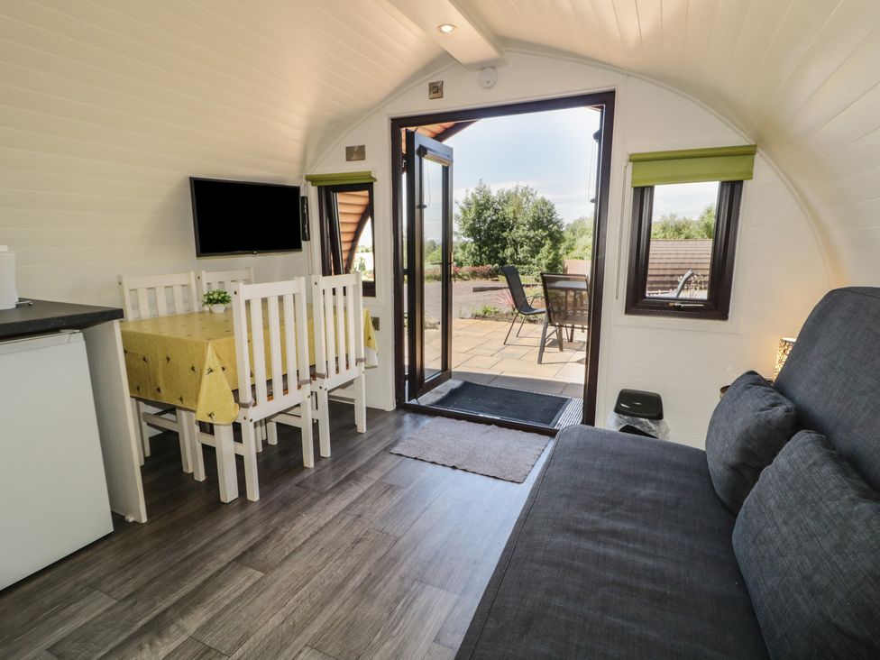 A living room with a dining table and chairs at Gortin Glen Glamping Pod 2 in Omagh