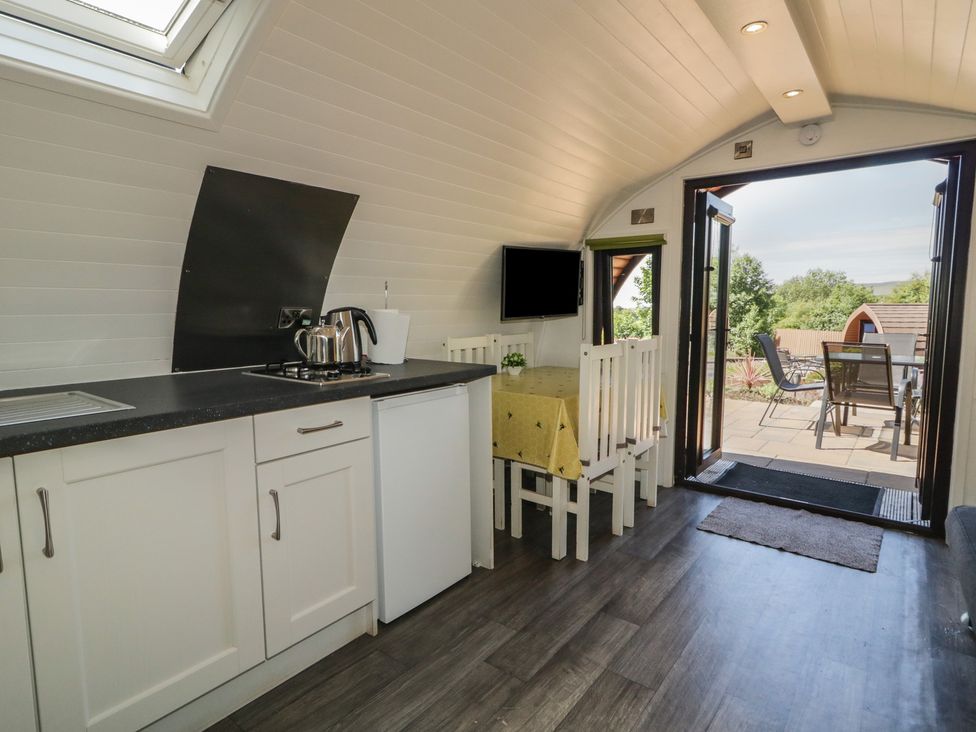 A kitchen area with a table and chairs at Gortin Glen Glamping Pod 2 in Omagh